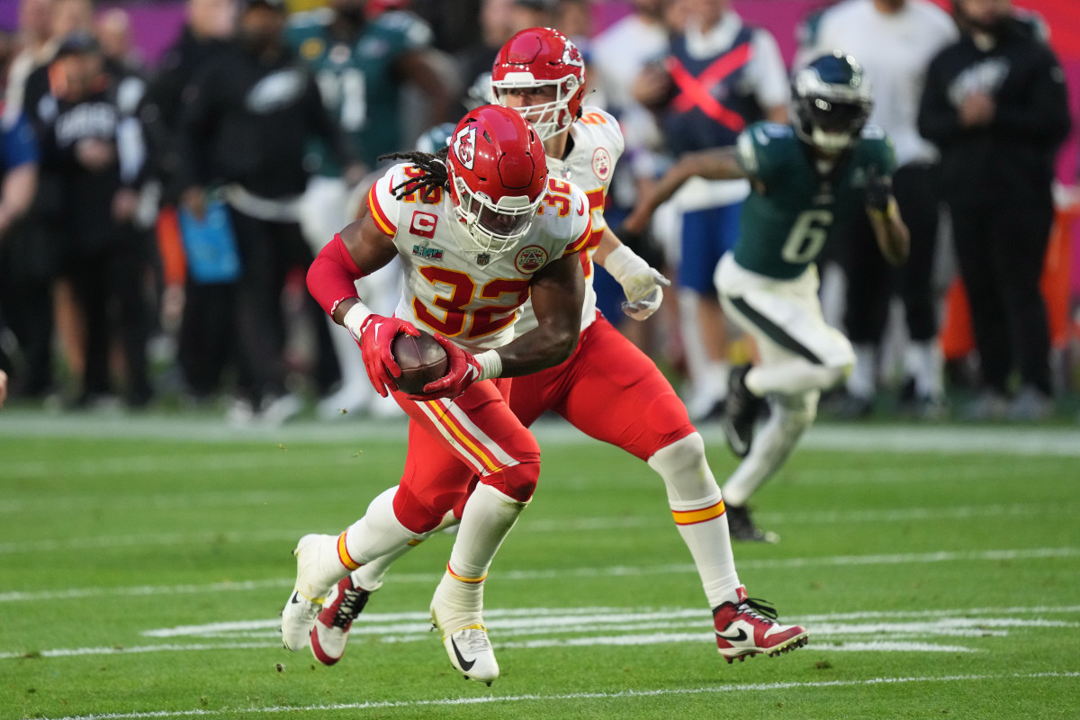 Feb 12, 2023; Glendale, Arizona, US; Kansas City Chiefs linebacker Nick Bolton (32) recovers a fumble and runs for a touchdown Philadelphia Eagles quarterback Jalen Hurts (1) in the second quarter of Super Bowl LVII at State Farm Stadium. Mandatory Credit: Joe Camporeale-USA TODAY Sports